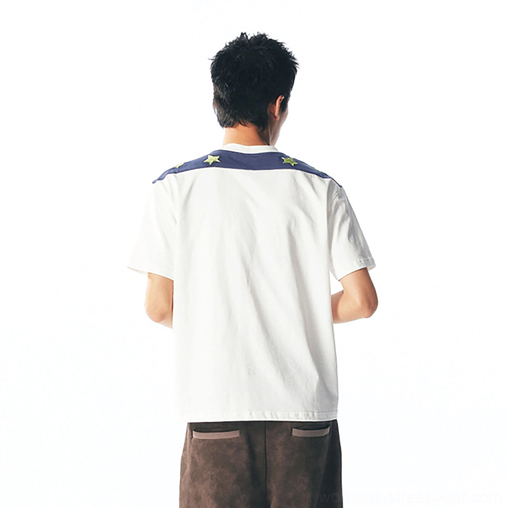 Back view of navy star shoulder panel on cartoon graphic unisex streetwear tee worn by male model