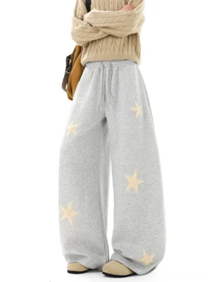 Gray ultra wide streetwear sweatpants with cream star patch embroidery and adjustable drawstring waist front view