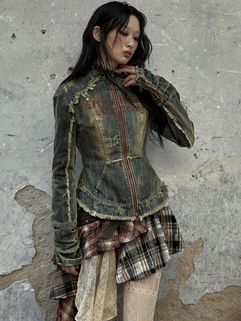 Statement distressed denim corset jacket with vintage-inspired fading and rebellious streetwear aesthetic