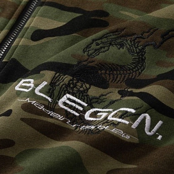 Statement green camo fleece jacket with oversized streetwear fit, relaxed utility aesthetic, and versatile zip-up design