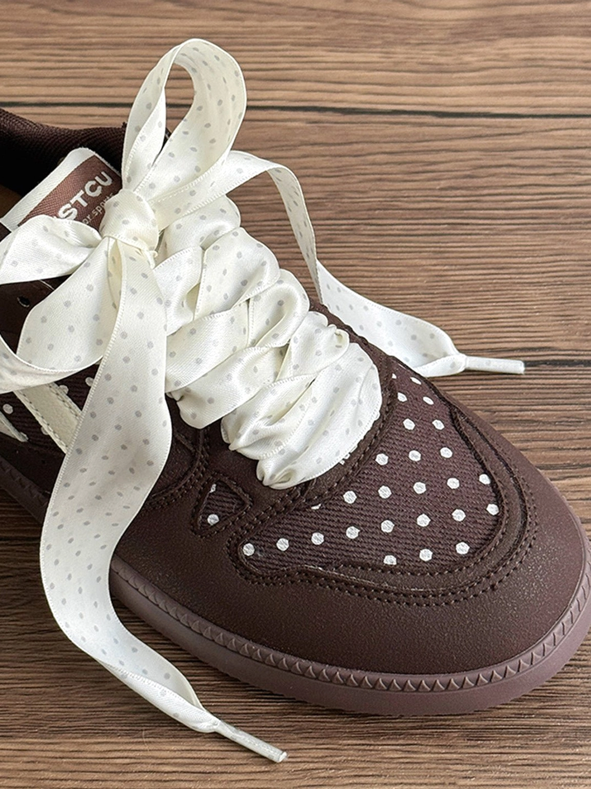 Statement ribbon lace skate sneakers with retro polka dot detailing and a thick flat rubber-style outsole