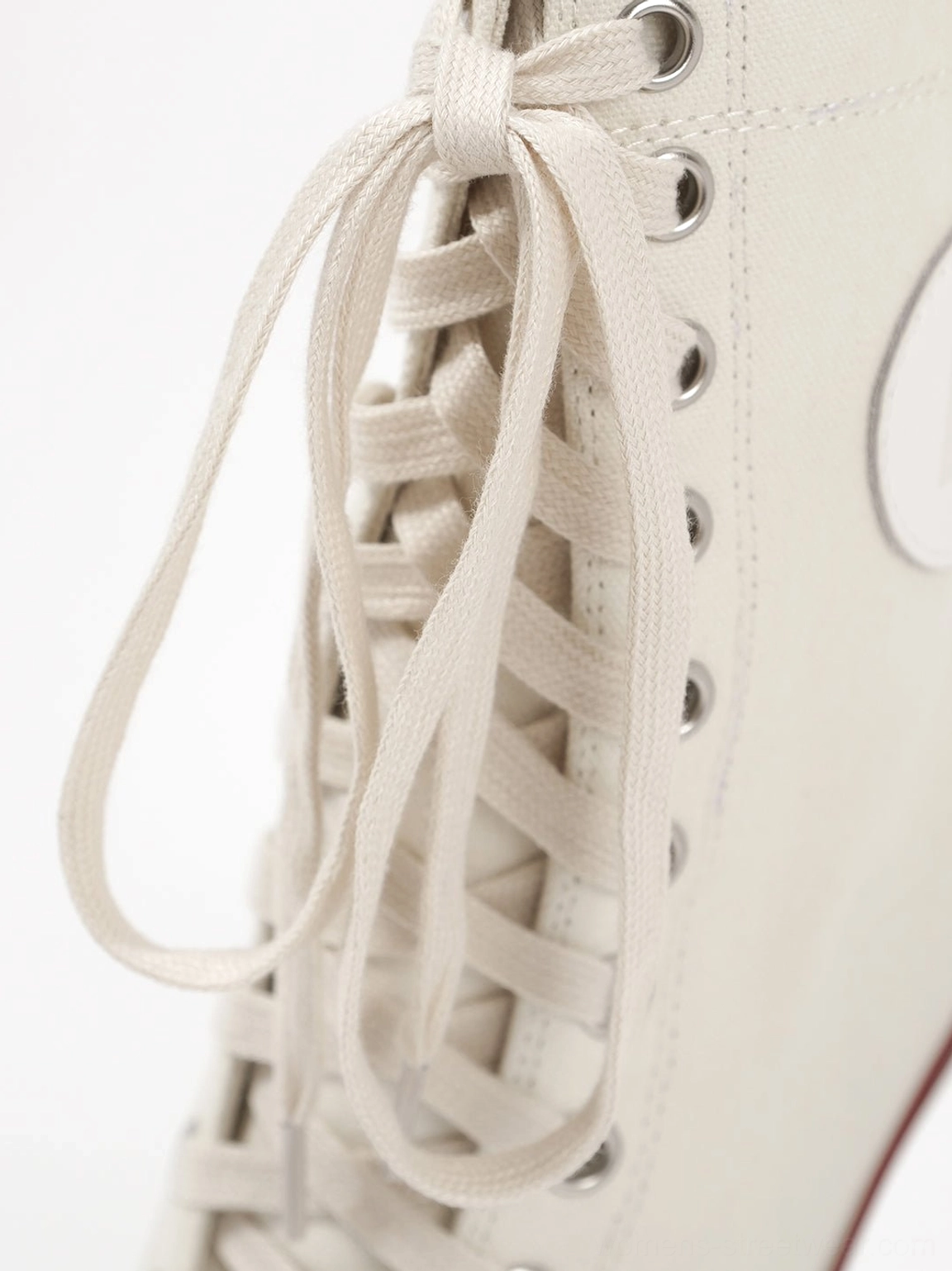 Canvas lace-up stiletto boots quarter-turn side view showing shaft height proportions ankle patch placement and full profile silhouette from lateral angle on white backdrop