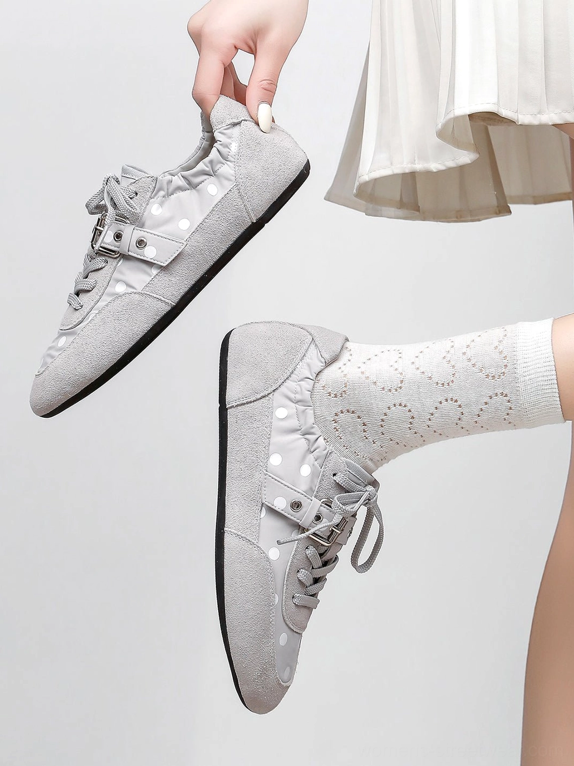 Streetwear ballet sneakers with retro polka dot pattern, slim buckle strap, and streamlined flat silhouette