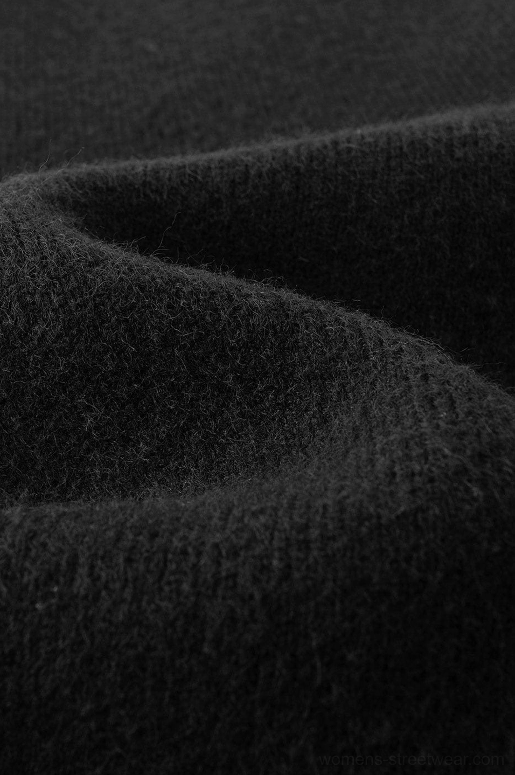 Streetwear fashion detail of V-neck racing stripe knit sweater with relaxed oversized silhouette and bold sleeve stripes