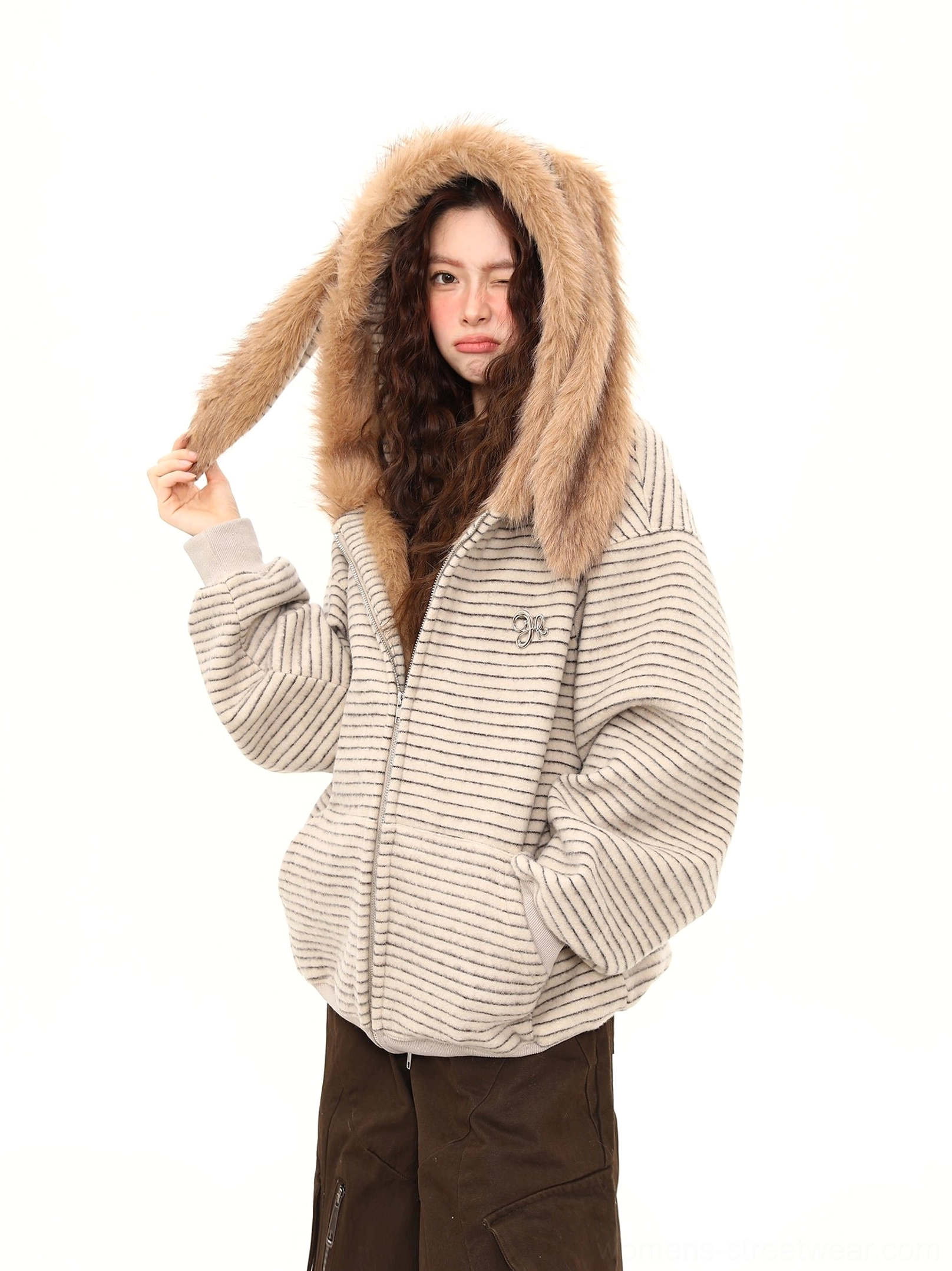 Close-up three-quarter view of a striped bunny-ear streetwear hoodie showing the plush faux-fur hood lining and relaxed drop shoulders