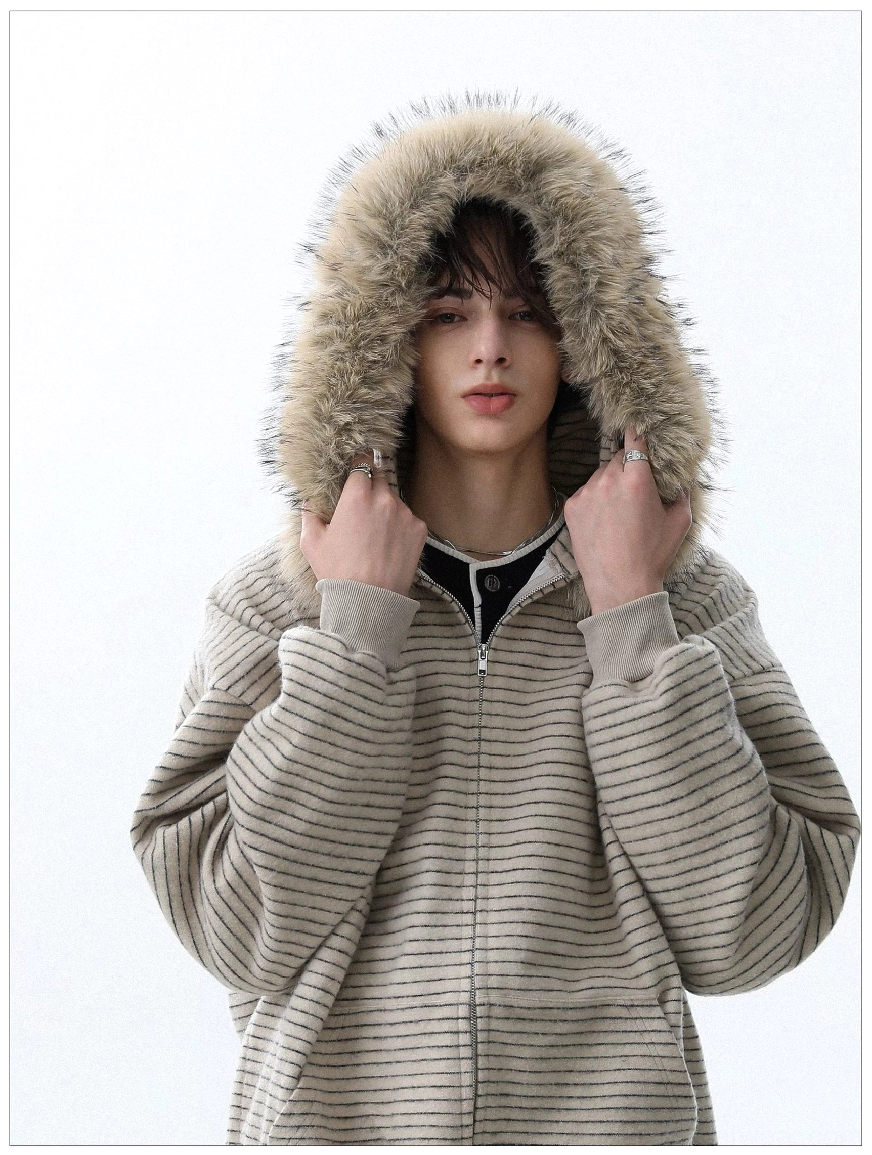 Close view of apricot striped hoodie and fluffy detachable faux fur hood trim
