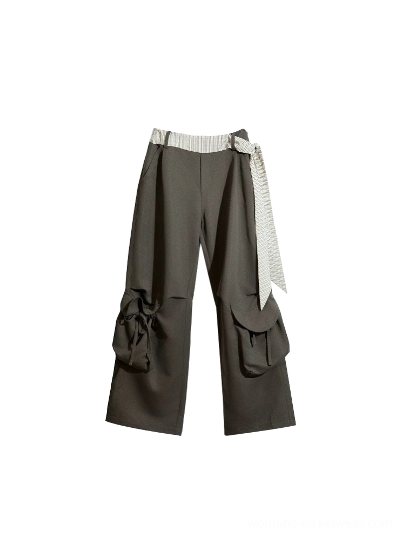 Dark gray wide-leg cargo pants flat lay showing striped sash belt, zip button waist, and oversized utility pockets
