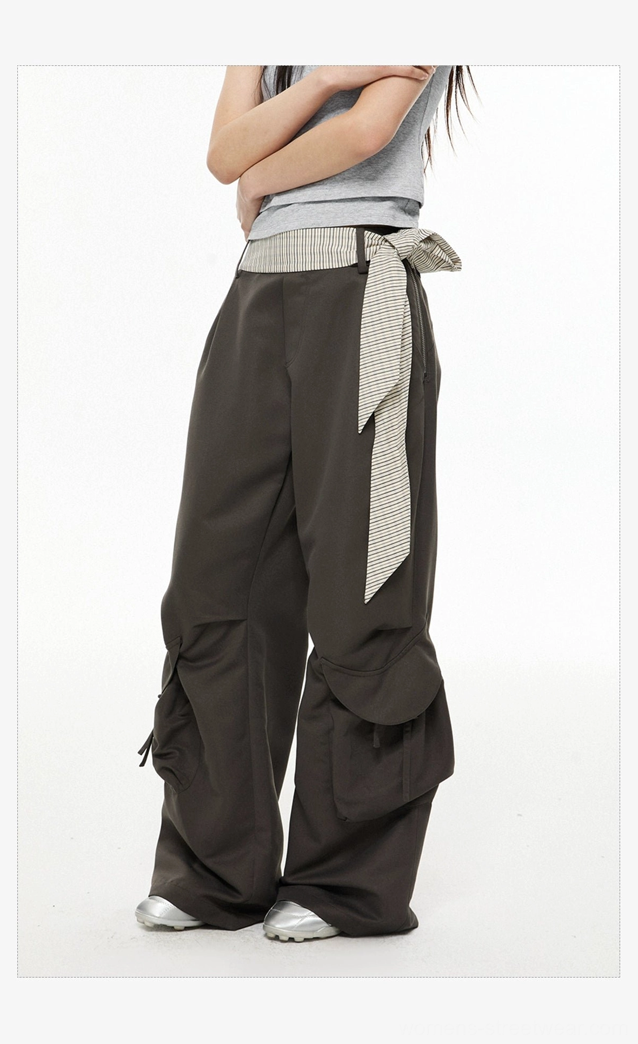 Side view of dark gray wide-leg streetwear cargo pants with tied striped sash belt and large utility pockets