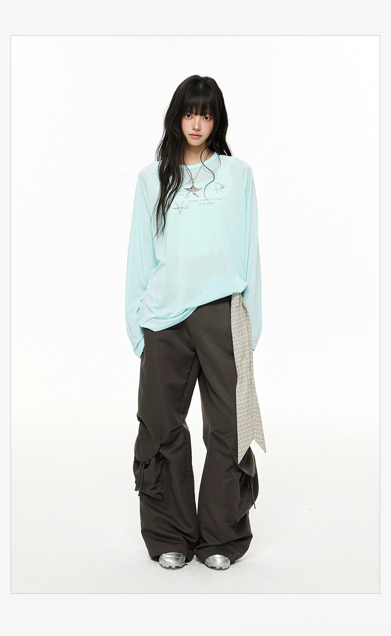 Dark gray relaxed-fit streetwear cargo pants with full-length wide legs and striped waist sash in a studio look