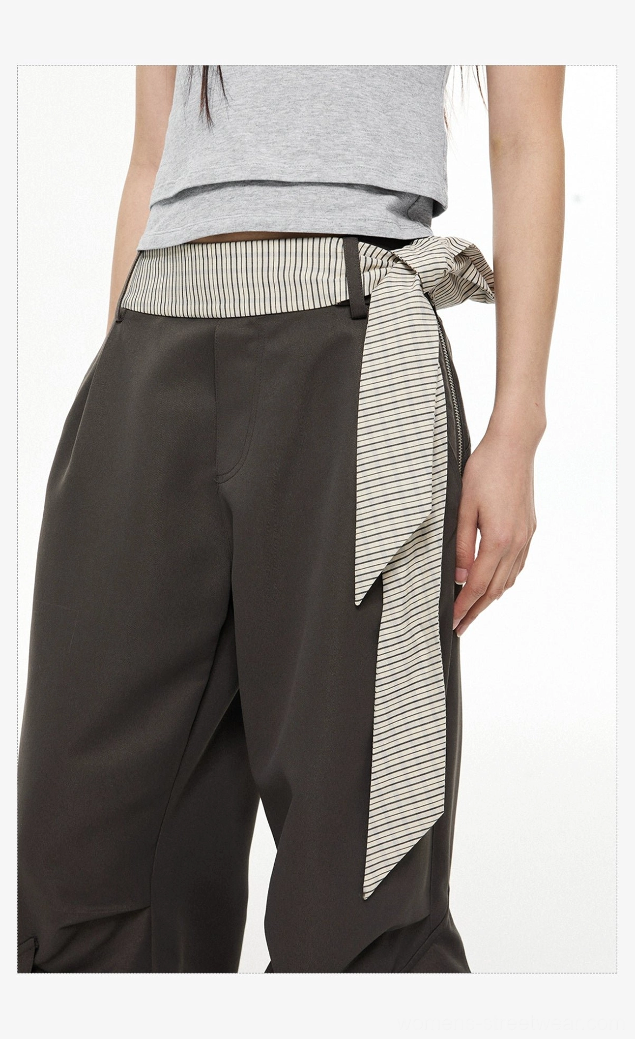 Close-up of striped woven sash belt and tailored waist detail on dark gray wide-leg cargo pants