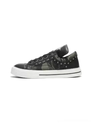 Side profile of studded camouflage panel platform sneakers with black faux leather overlays silver tone rivets and white rubber sole
