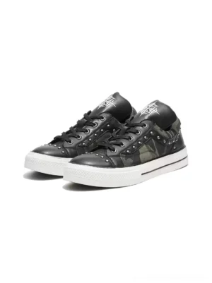 Front three quarter view of pair of studded camo platform sneakers with black laces metal rivets and contrasting white soles