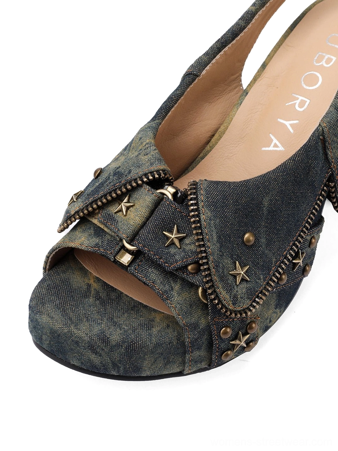 Close-up of studded denim peep-toe slingback heel with buckle strap star rivets and zipper edge