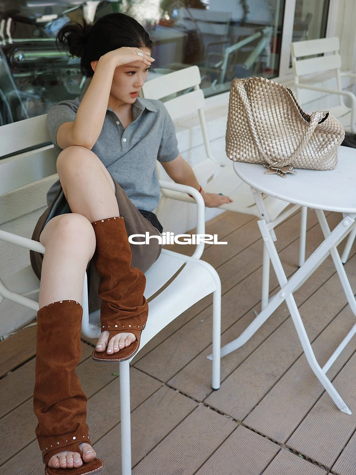 Close overhead fashion view of brown studded suede thong sandal boots showing the rivet-trimmed cuff and open toe