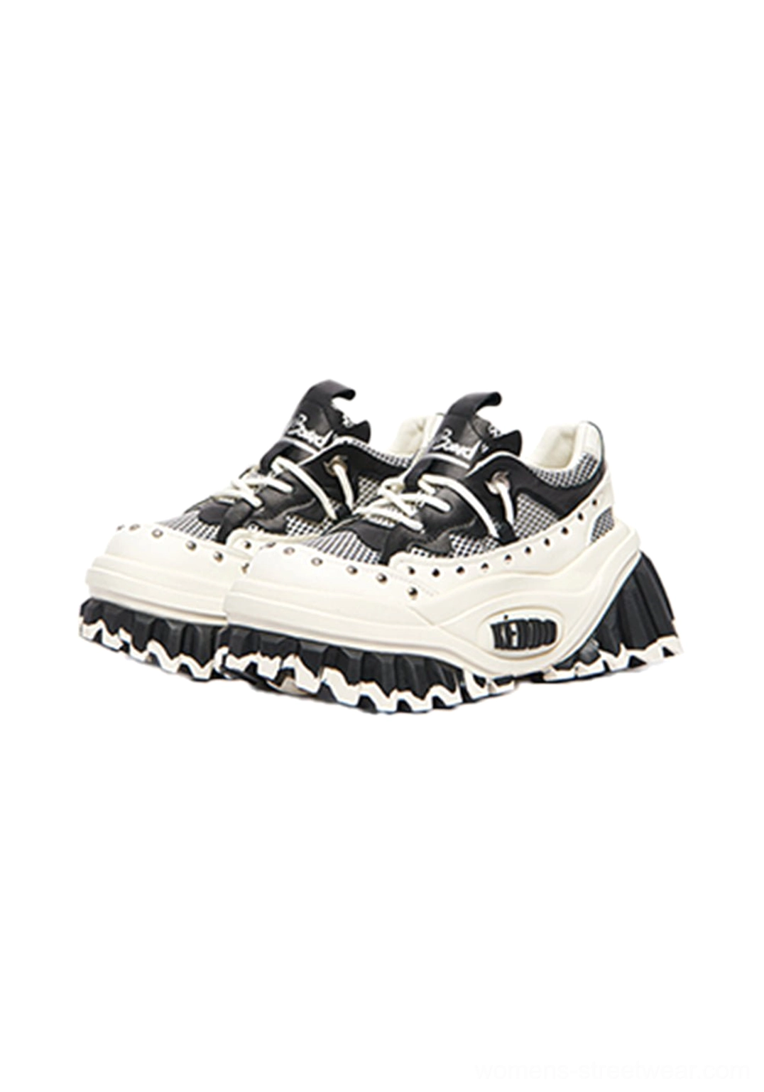Front view of black and white studded wave-sole platform footwear with mesh upper and chunky rubber outsole