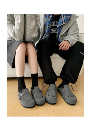 Matching couple wearing dark grey suede buckle cork footbed streetwear mule clogs with crew socks