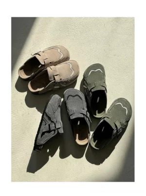 Suede buckle cork footbed streetwear mule clogs in dark grey and sand shown in a top-down flat lay