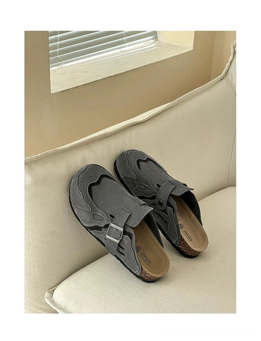 Dark grey suede buckle cork footbed streetwear mule clogs with exposed contoured footbed on sofa
