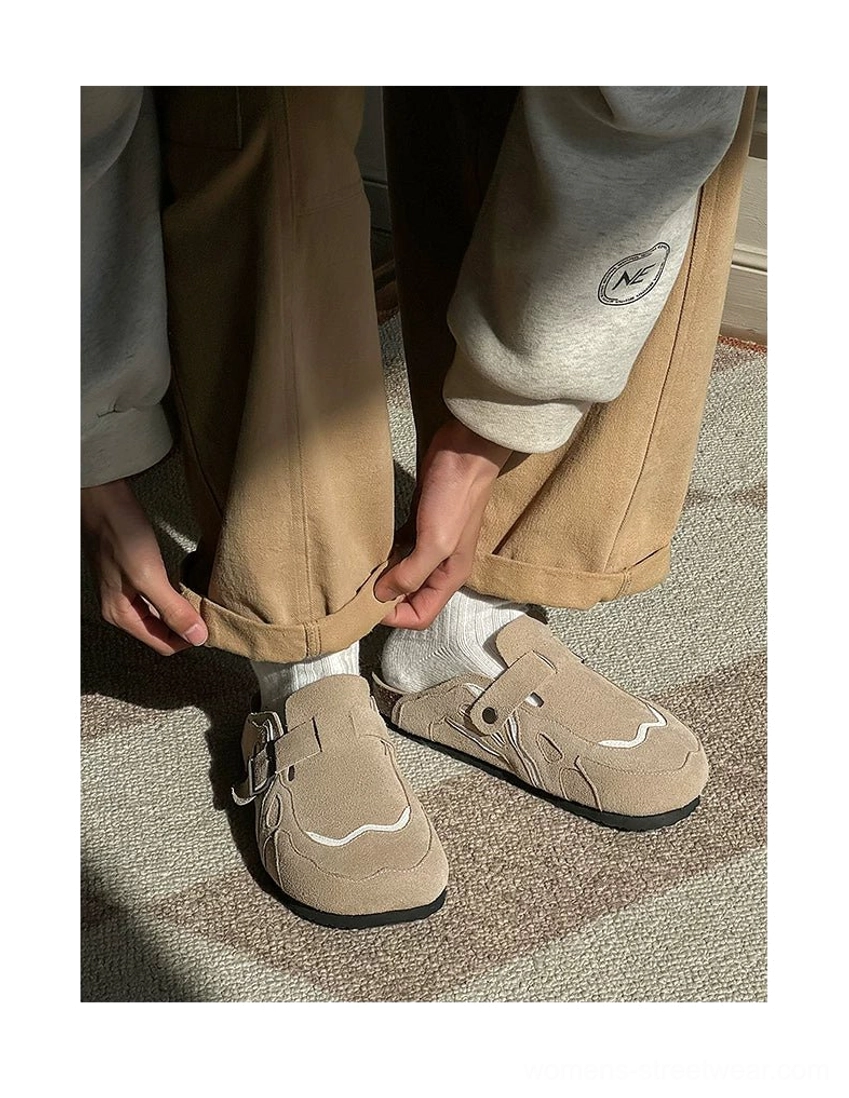 Taupe suede buckle cork footbed streetwear mule clogs styled with white crew socks and relaxed pants