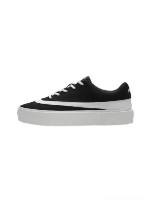 Black and white suede-textured colorblock platform sneakers shown from the left side on a clean white background