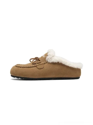 Apricot suede-look shearling moccasin slippers in side view with plush collar, front bow, and whipstitch toe detail