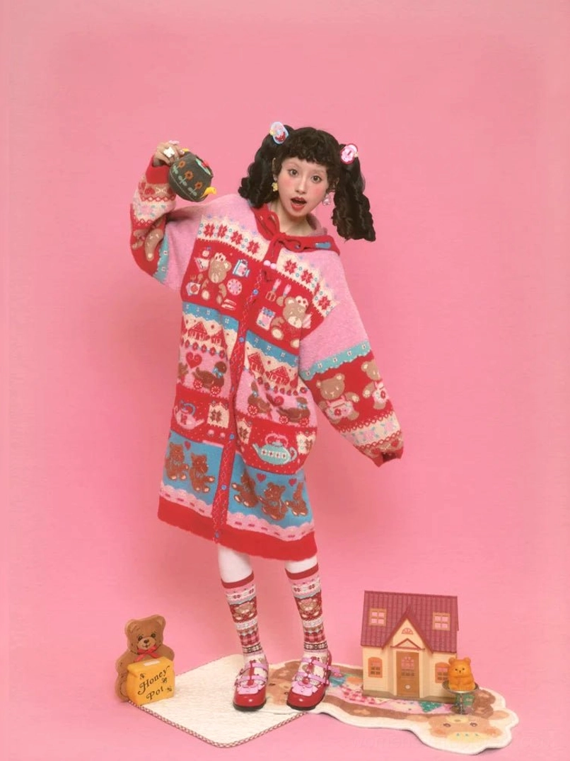 Front full body view of sweet bear Fair Isle hooded long cardigan styled with patterned socks and red shoes in kawaii streetwear look