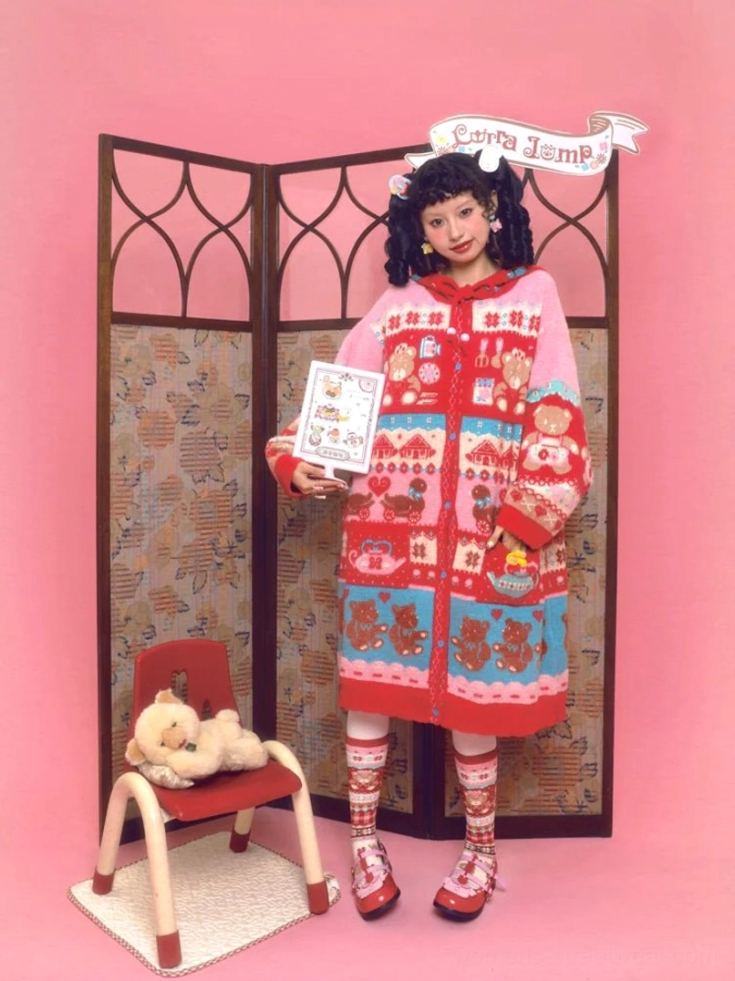 Sweet bear Fair Isle hooded long cardigan worn in a pink retro studio, featuring colorful red pink and blue bear jacquard knitwear