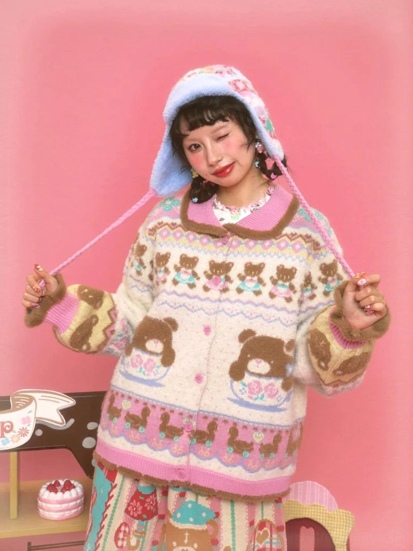 Sweet Bear Tea Party ivory knit cardigan with teddy bear and teacup Fair Isle motifs, pink trim, fuzzy cuffs, and matching bonnet styled in a pastel café setting