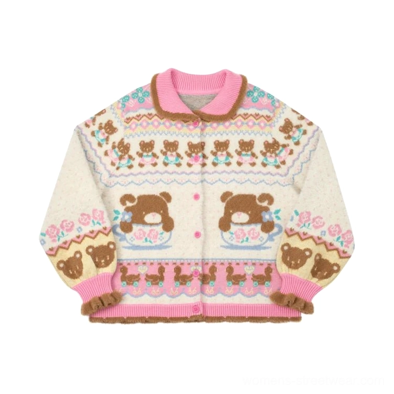 Flat lay of ivory Sweet Bear Tea Party knit cardigan with pink collar and hem trim, front buttons, teddy bear teacup jacquard pattern, and fuzzy brown cuffs