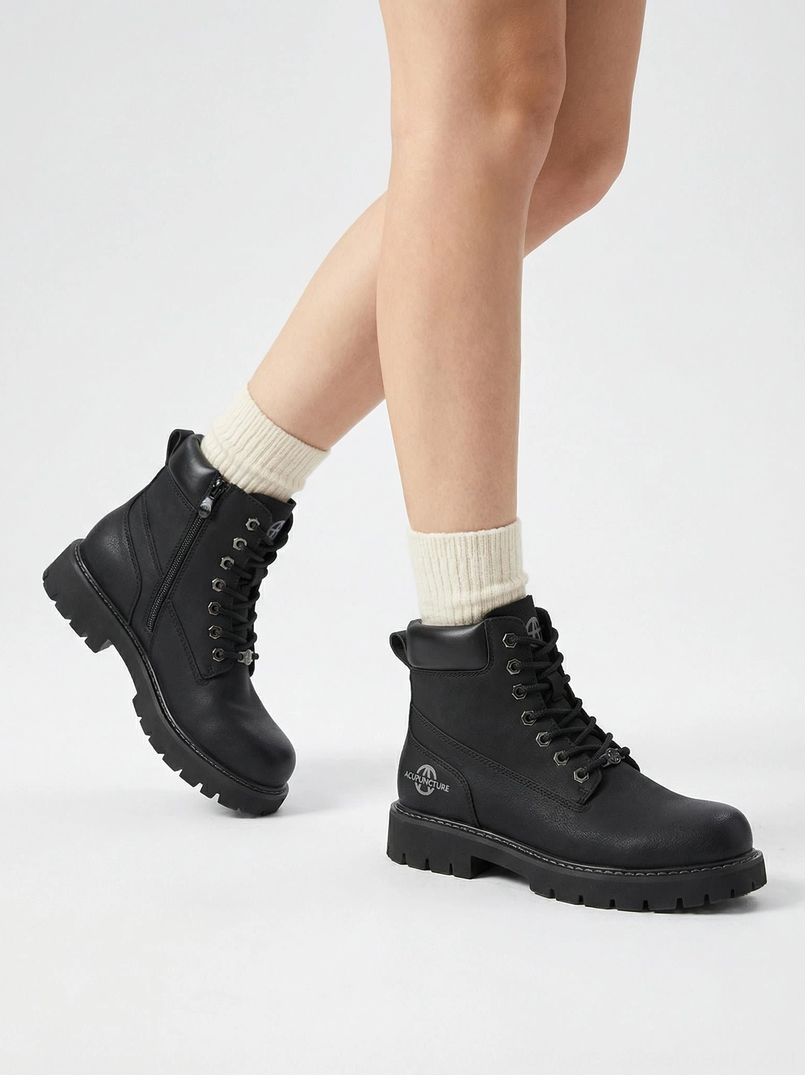 Tactical zip-front ankle boots flat lay composition studio background minimalist techwear aesthetic