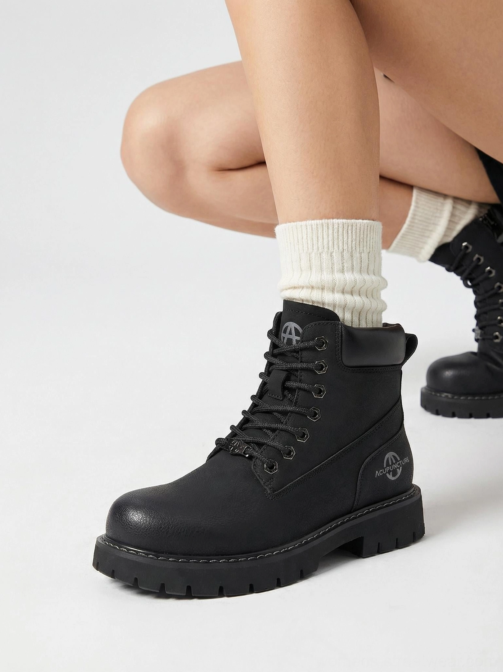 Tactical zip-front ankle boots on feet lifestyle styling street photography urban environment casual wear