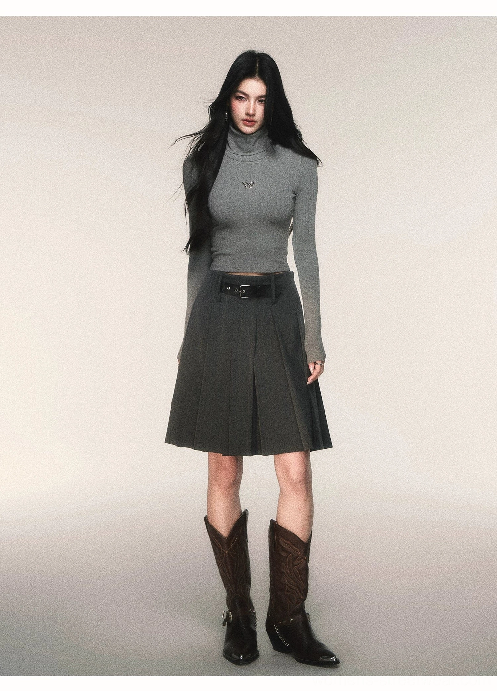 Tailored charcoal gray A-line pleated midi skirt with pinstripe texture black belt and brown cowboy boots