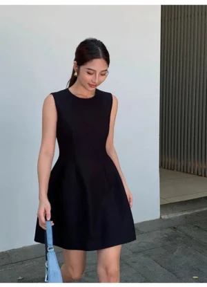 Black tailored sleeveless A-line mini dress with crew neck and sculpted waist shown in a full body urban streetwear look