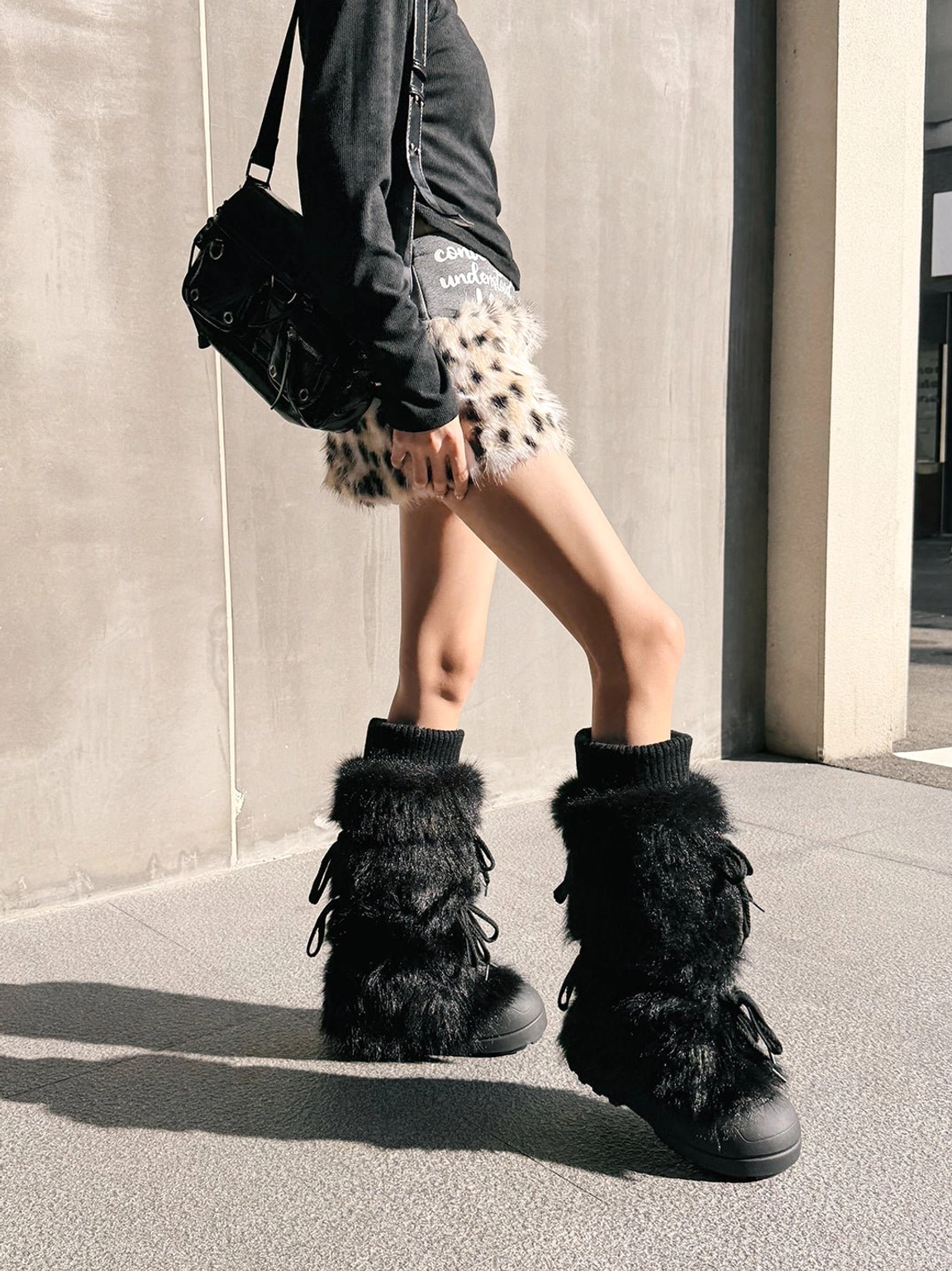 Tall plush-lined platform boots paired with oversized denim and modern streetwear layers