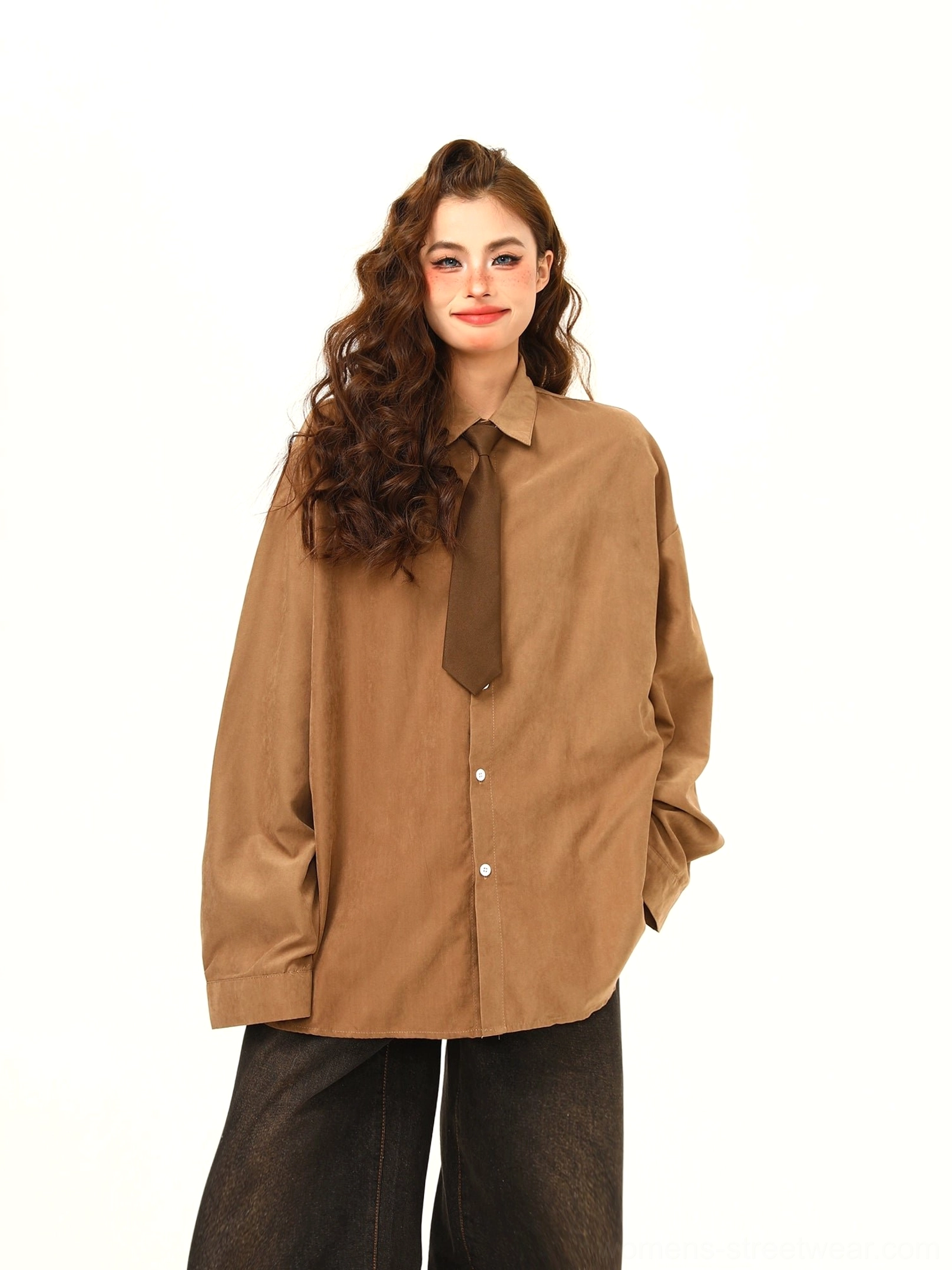 Medium front view of tan brown oversized corduroy shirt with white buttons, classic collar, matching brown tie, and wide-leg denim