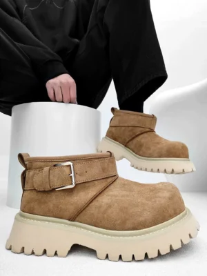 Tan suede-finish buckle platform boots with off-white chunky tread photographed from a low studio angle