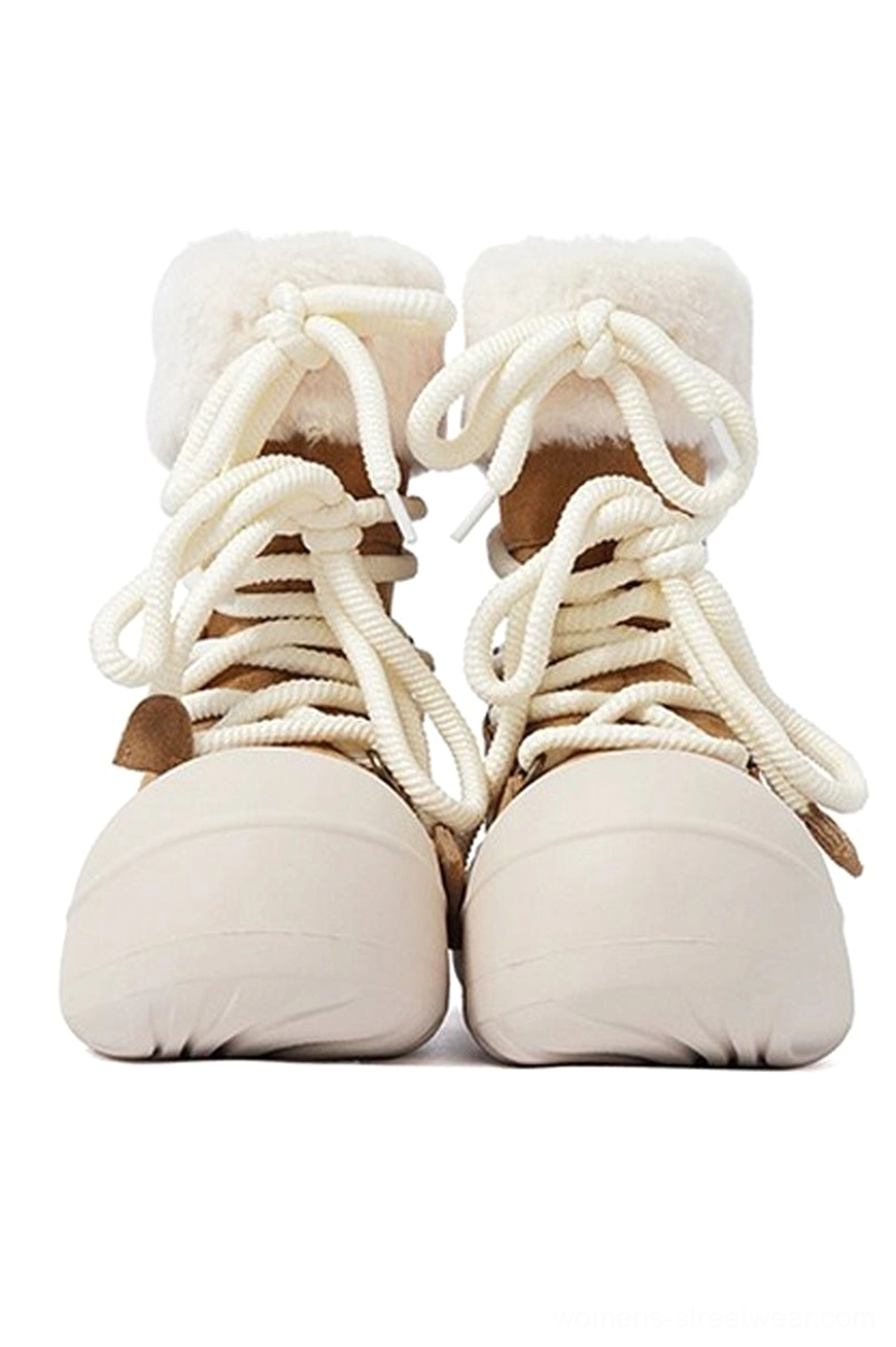 Front view of tan suede winter boots with white fleece collar cream laces and oversized rounded platform sole