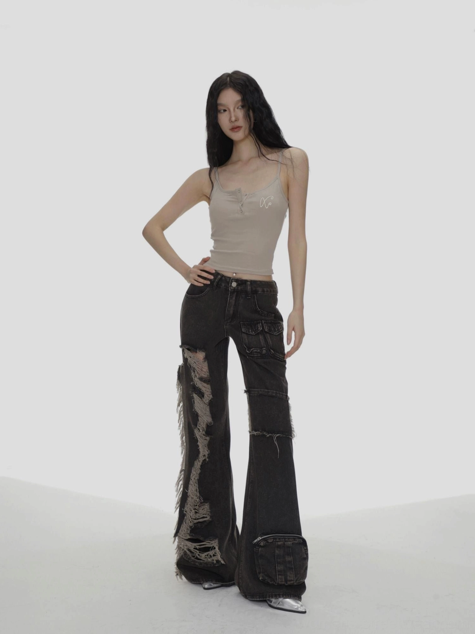 Taupe beige slim fit spaghetti strap camisole styled with ripped flared black jeans for a Y2K streetwear outfit