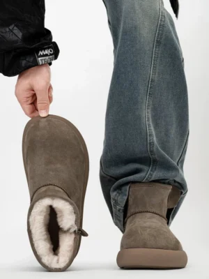 Taupe brown shearling-lined suede platform ankle boots shown in a flat lay and worn with blue denim for winter streetwear styling