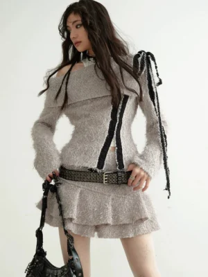 Taupe fuzzy knit off-shoulder streetwear top with black ribbon trim styled with a studded handbag