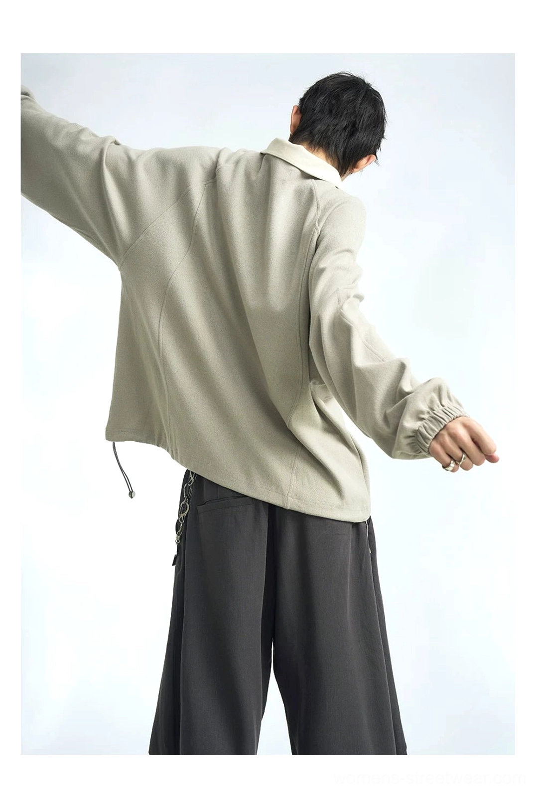 Back view of taupe gray half-zip raglan polo pullover with contrast collar and adjustable drawstring hem