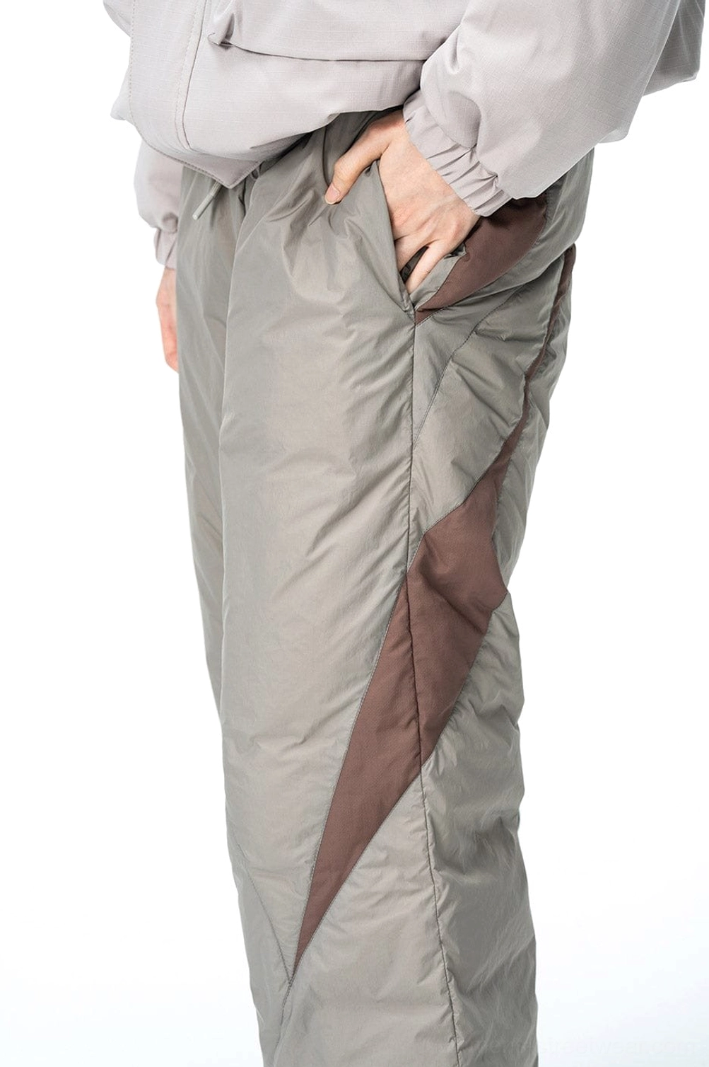 Spliced padded streetwear track pants in taupe gray with dark brown color-block panels and quilted wide-leg design