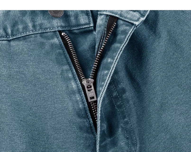 Teal carpenter denim pants front fly close-up with matching waistband button, metal zipper, and textured cotton fabric