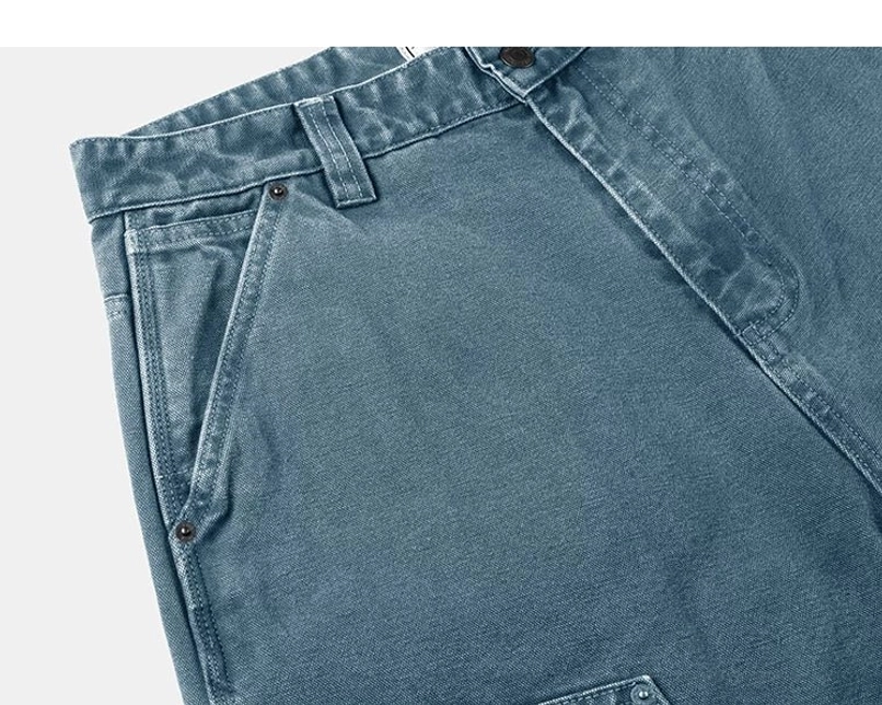 Teal women's carpenter streetwear pants side pocket close-up with faded canvas finish, rivets, and precise stitching