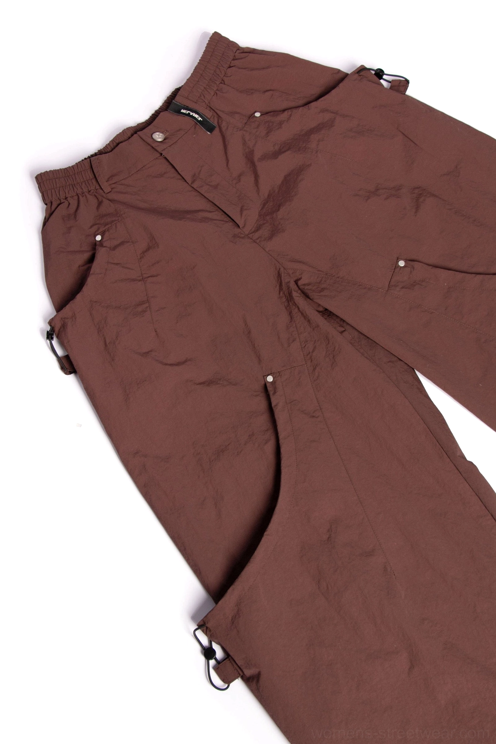 Techwear inspired wide leg cargo pants with adjustable ankle hems and relaxed modern streetwear fit