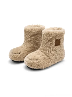 Pair of khaki teddy fleece platform ankle boots with rounded toes and black chunky soles front view