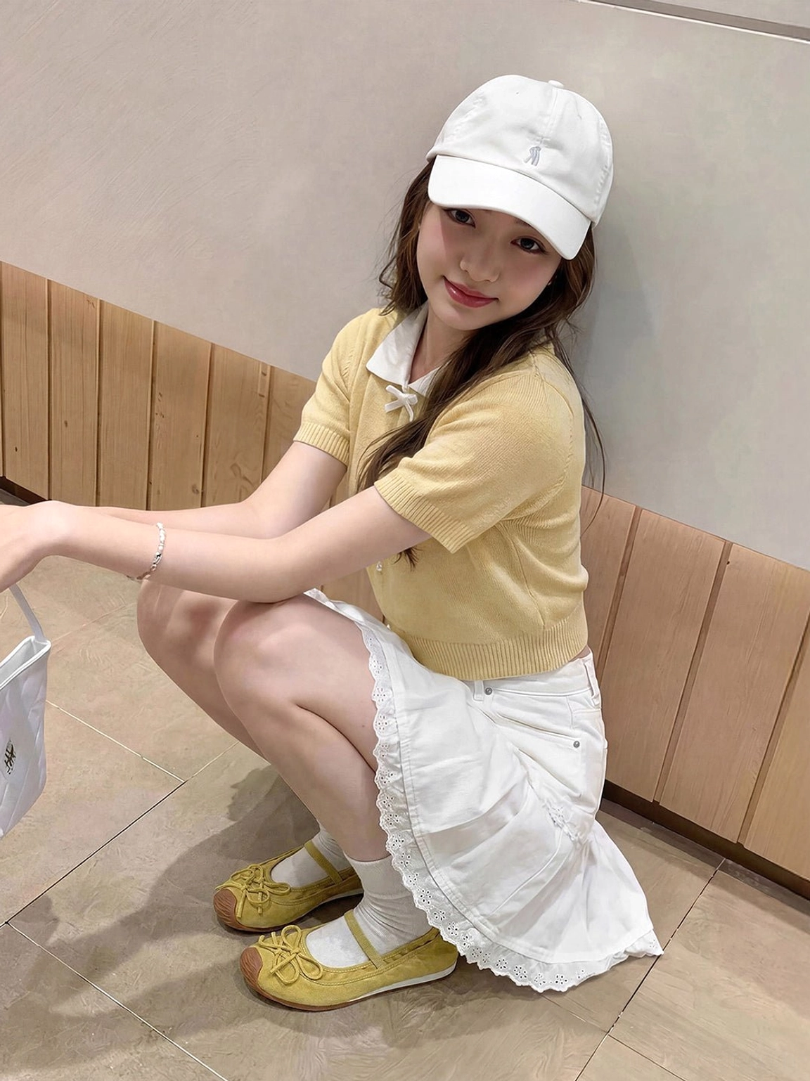 Yellow textured Mary Jane ballet flats styled with white ruffled skirt and socks for sweet Korean streetwear