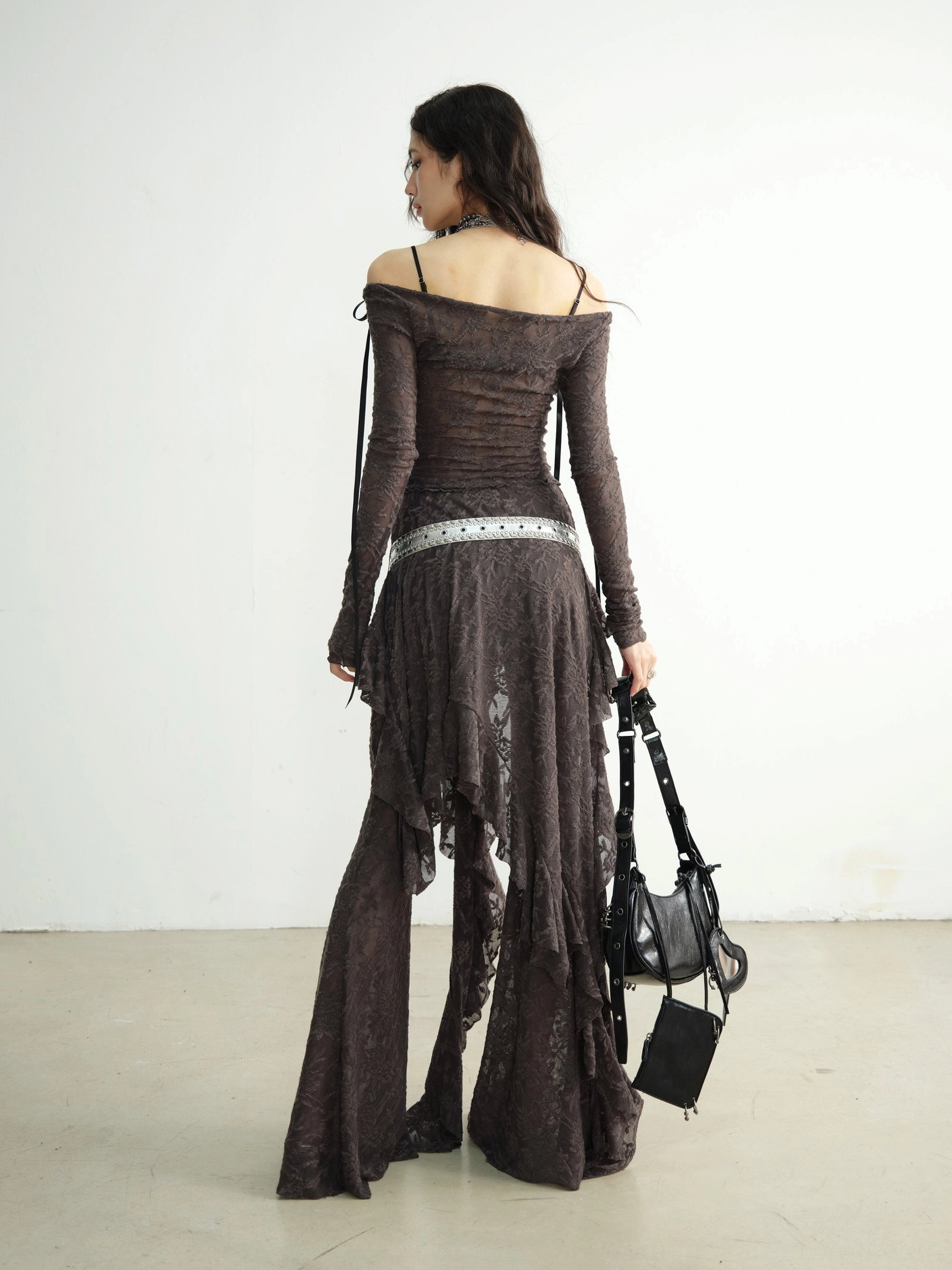 Back view of high waisted flared lace dance pants with exposed back detail and ruffled top drape