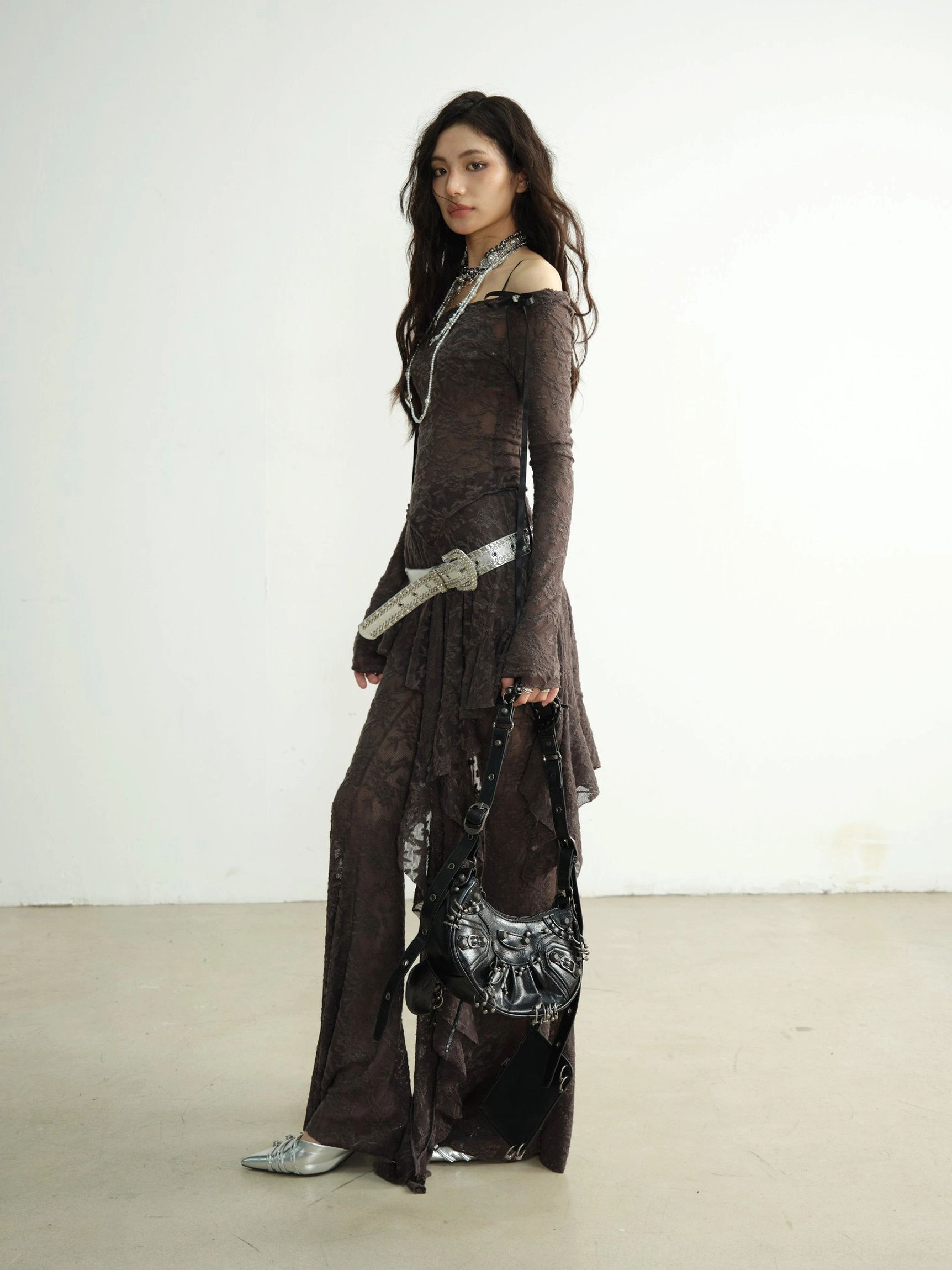 Side view of flared textured lace dance pants with silver pointed shoes and metallic black handbag