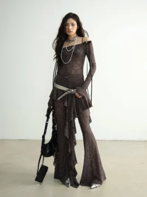 Three quarter view of off shoulder textured lace dance pant set with fitted sleeves silver belt and pointed shoes